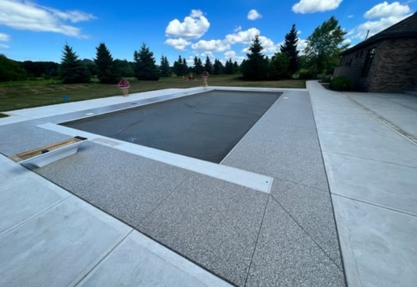 A beautiful new concrete coating on a residential pool deck